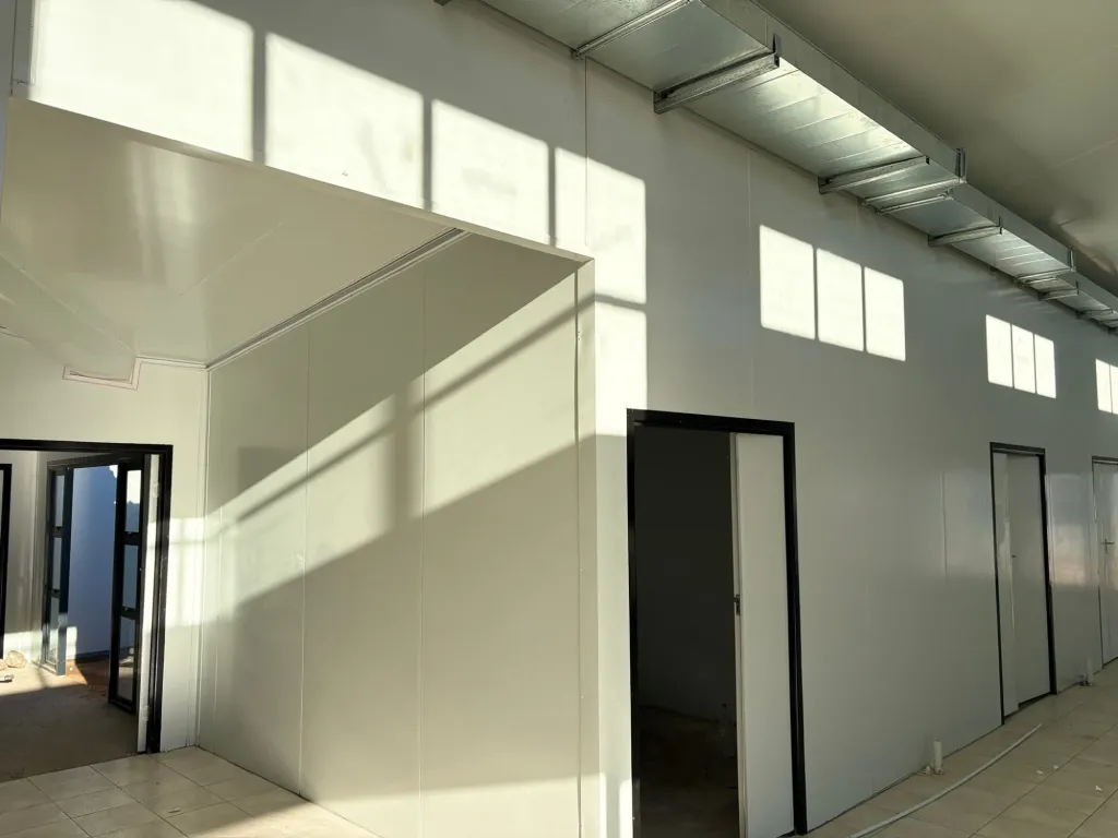 Prefab building interior with cable trays and internal doors