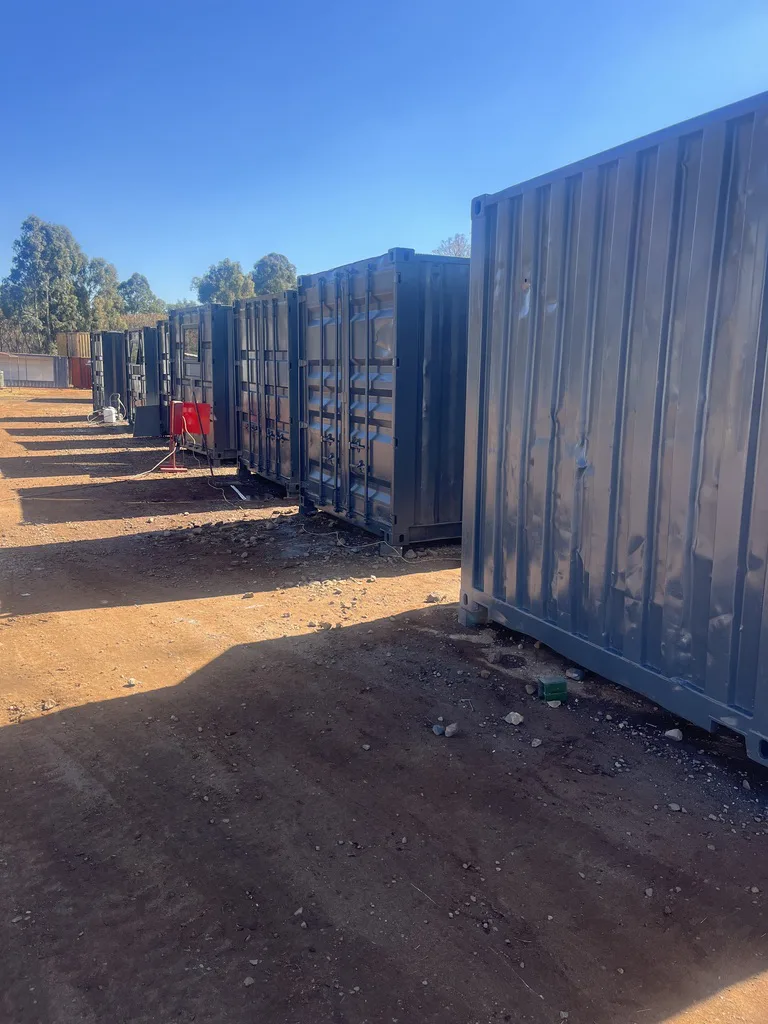 Row of painted containers for sale in our yard