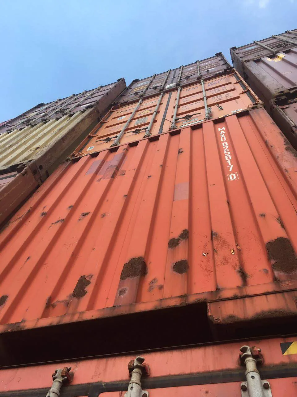 Stacked used cargo-worthy shipping containers